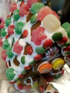 A depth of field view of a gingerbread house under construction
